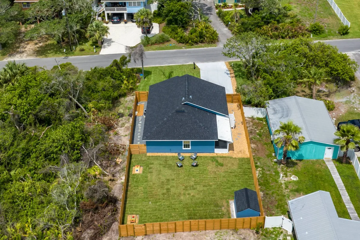 Aerial view of the house and fully fenced backyard