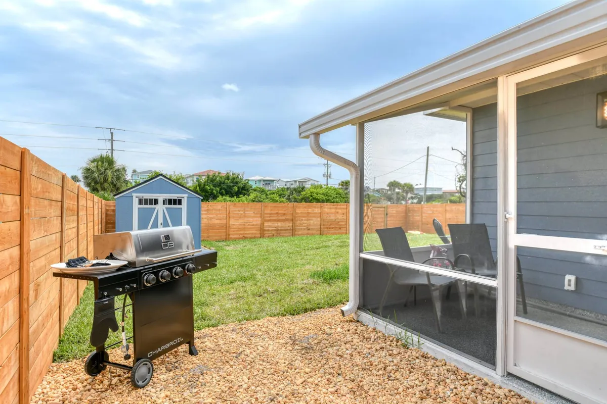 Gas grill beside the screened porch