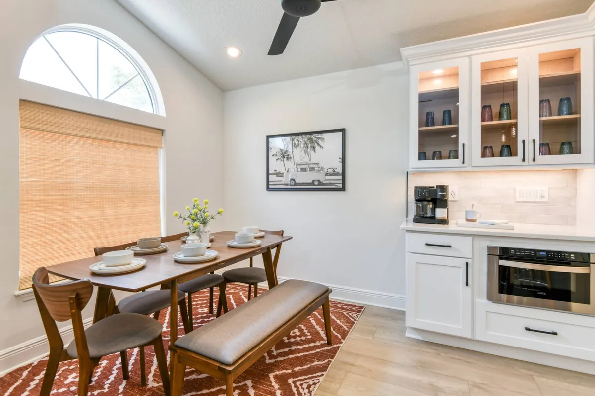 Dining area with bench seating under arched window